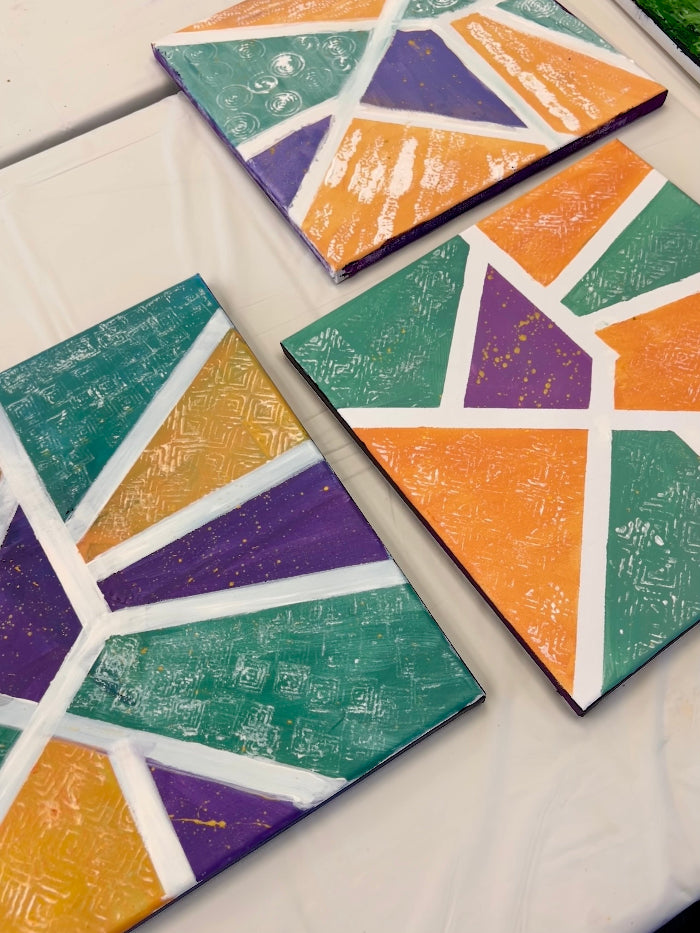 Colorful geometric-patterned tiles on a white surface