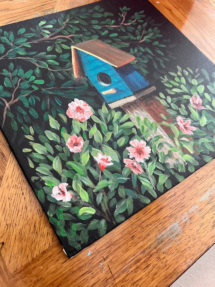 birdhouse and flowers art on black canvas