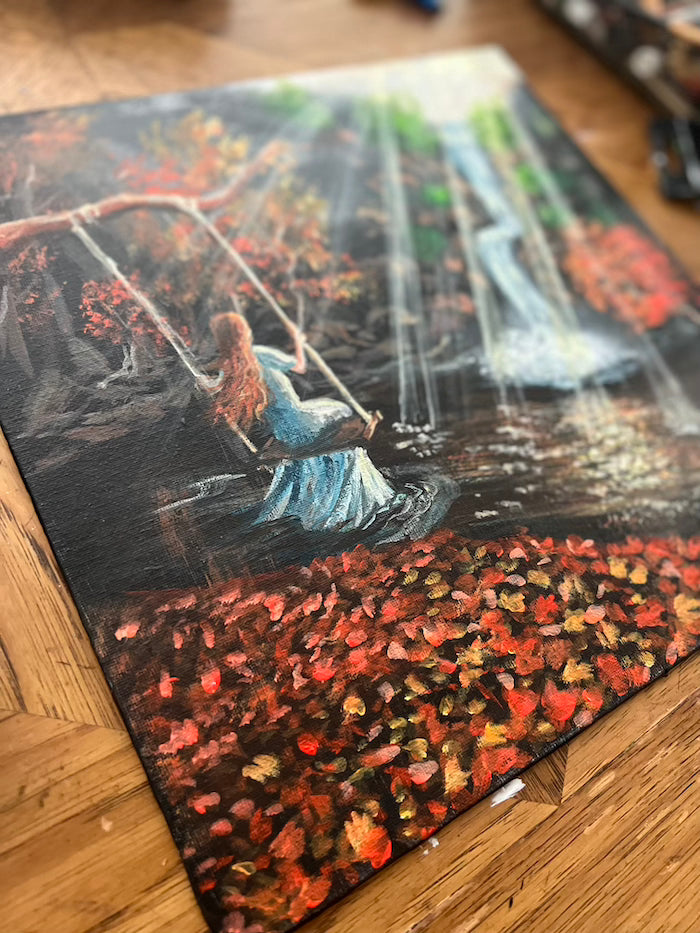 A woman on a swing painting